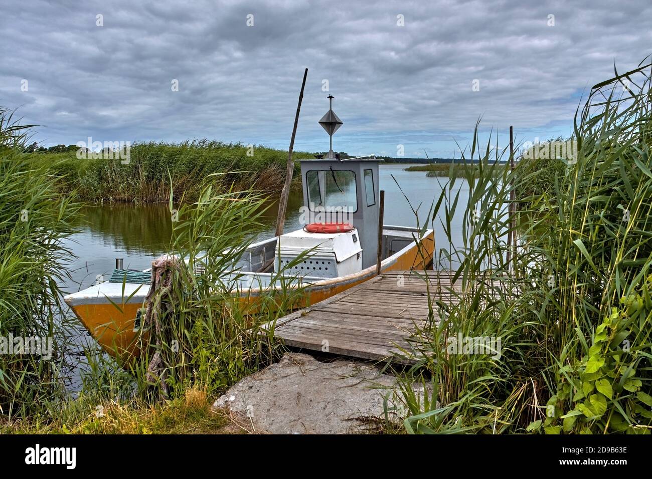 Fishing boat moored by the pier Stock Photo - Alamy