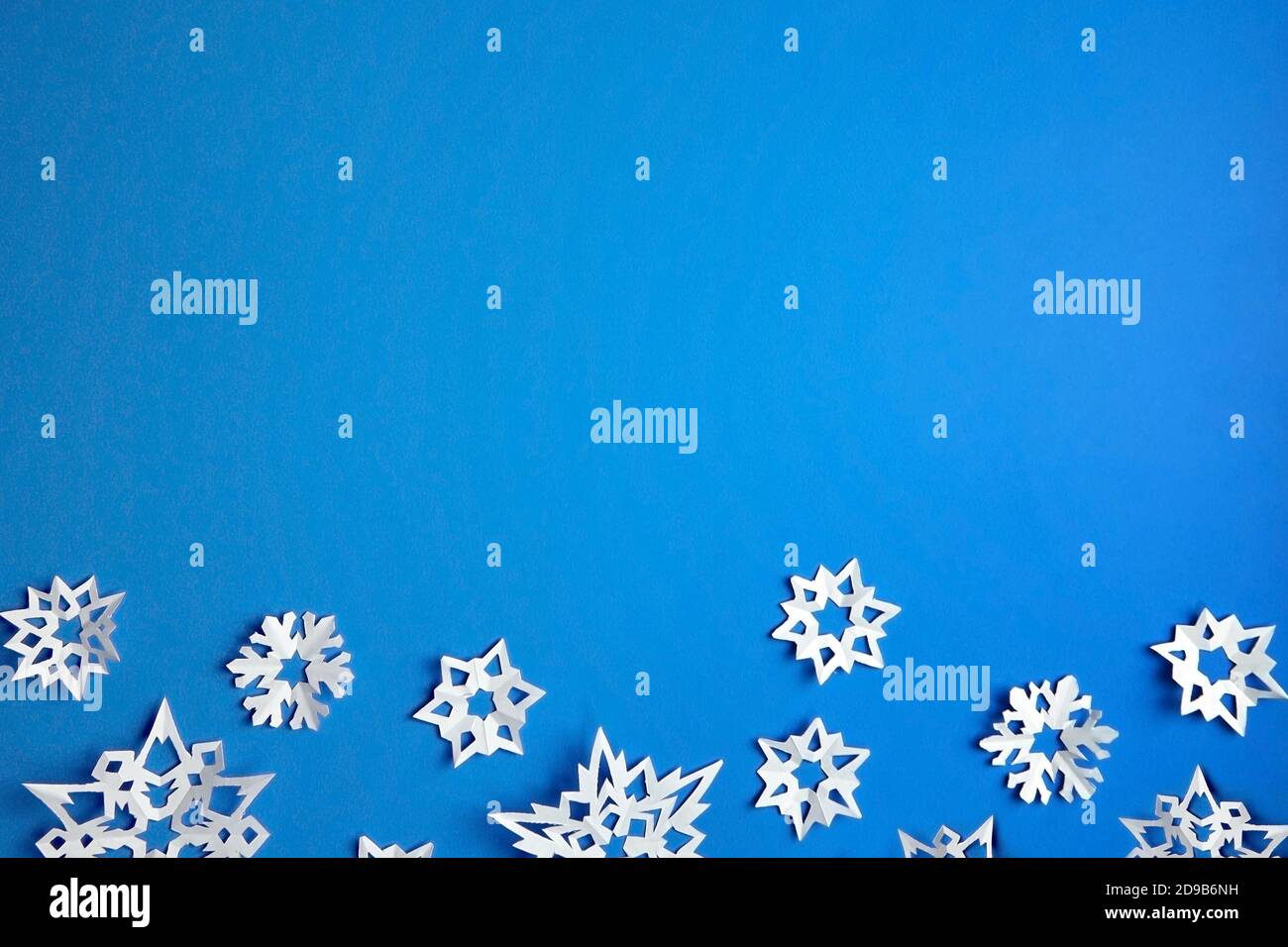 Composition with white paper snowflakes on blue background Stock Photo ...