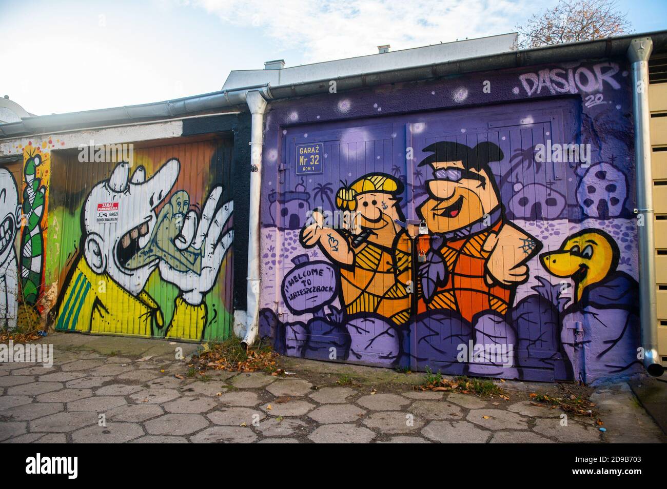 Graffiti mural of Flintstones cartoon seen in Gdansk Wrzeszcz. Murals are very popular in large Polish cities and are a kind of art. Stock Photo