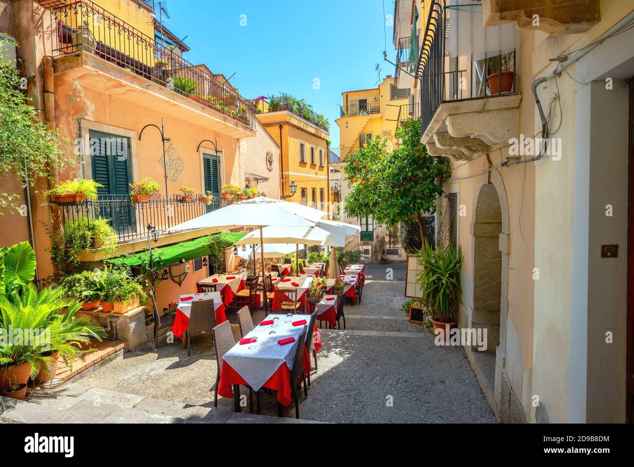View of colorful narrow pedestrian street with cafe in old town Taormina. Sicily, Italy Stock Photo
