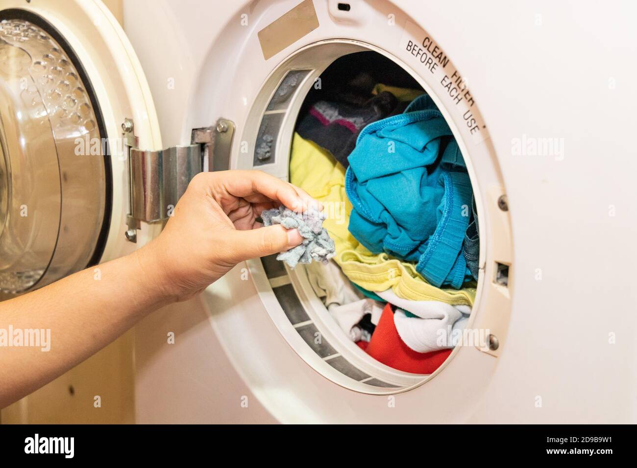 Handful of lint trapped in filter of laundry dryer machine Stock Photo