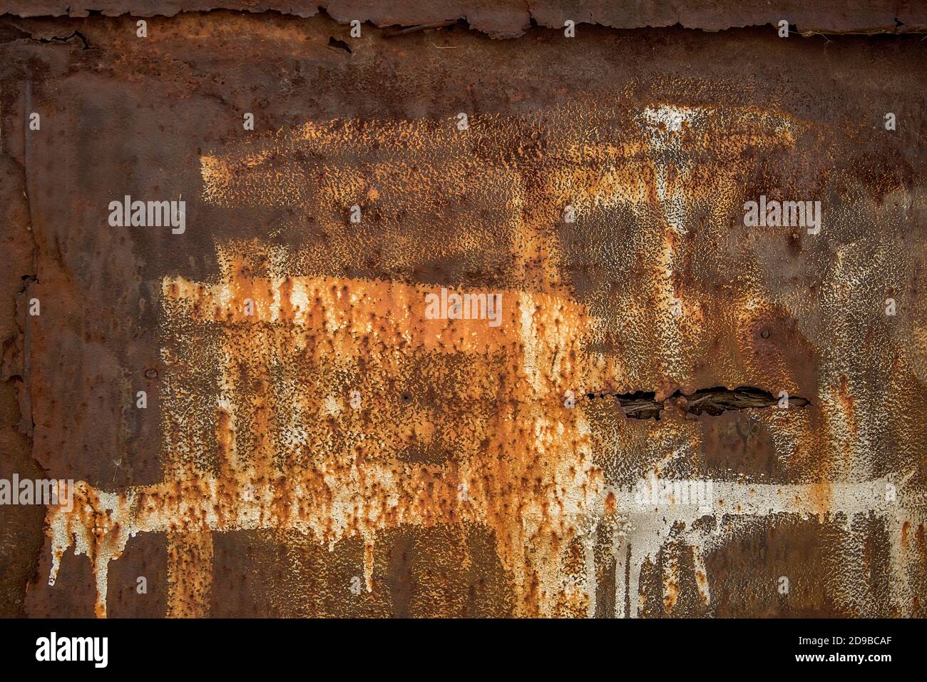 Background. Rusty iron texture with an abstract spot of white paint. Stock Photo