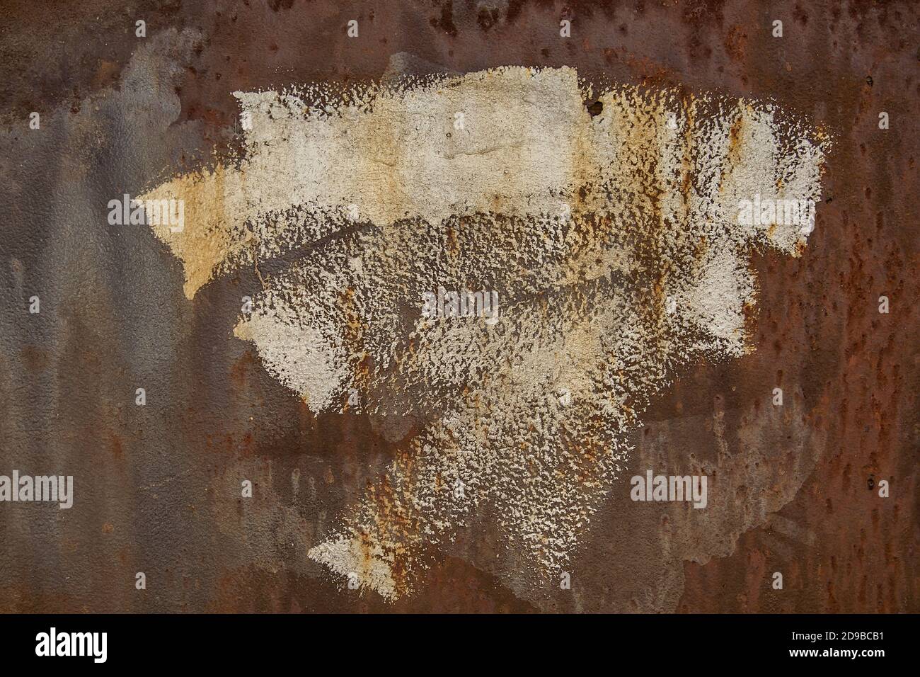 Background. Rusty iron texture with an abstract spot of white paint. Stock Photo