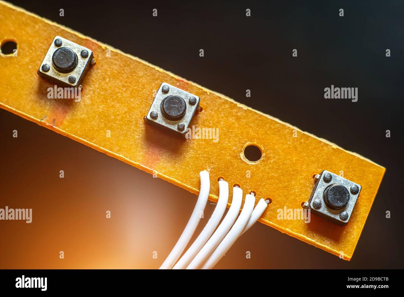 buttons on the circuit Board close up on a black background. Stock Photo