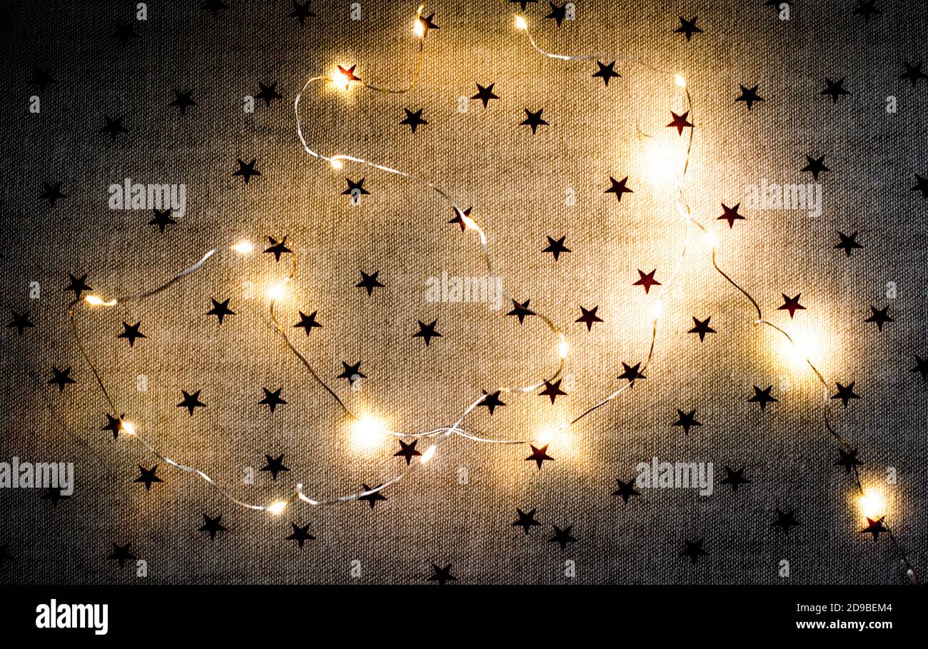 Wallpaper with Christmas garland and glowing lights Stock Photo - Alamy