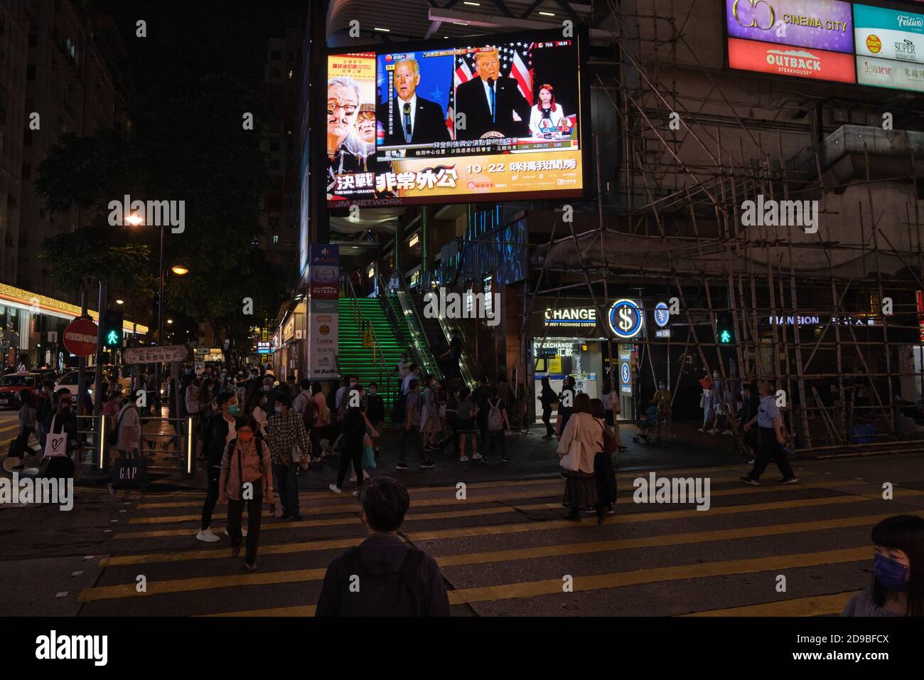 A public screen on Hong Kong street broadcasts a live news report of the US Presidential elections. Stock Photo