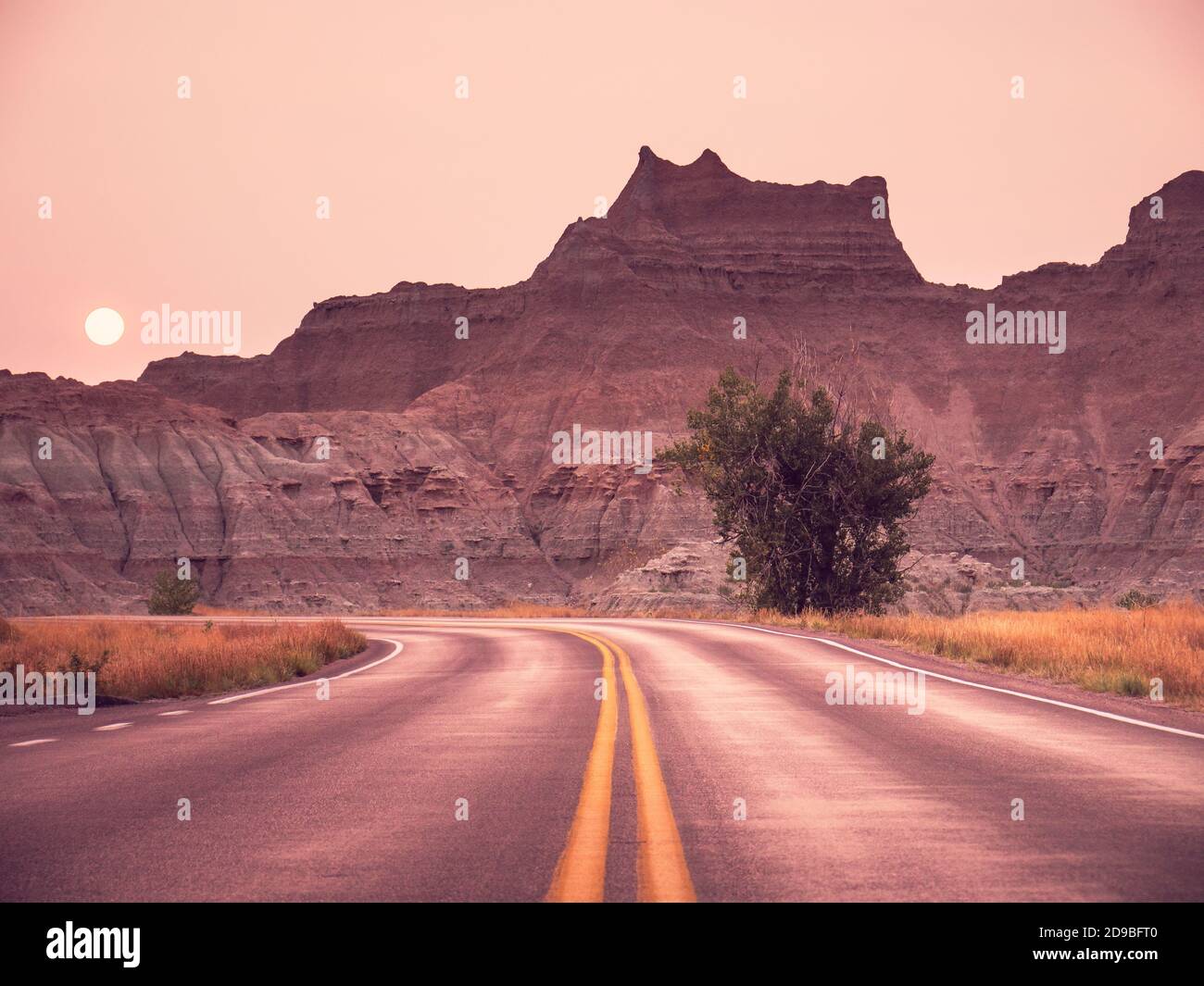 Badlands National Park Road at Sunset during wildfires, South Dakota, USA Stock Photo