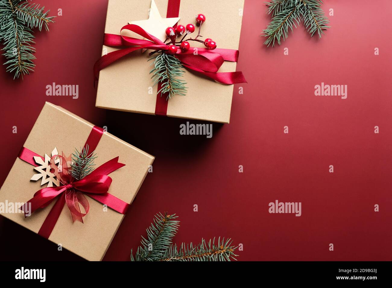 Christmas gift boxes with red ribbon bow and decorations on marsala red ...