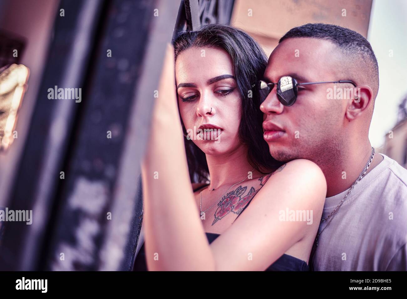 Sad Love couple portrait in urban context with cold colors Stock Photo