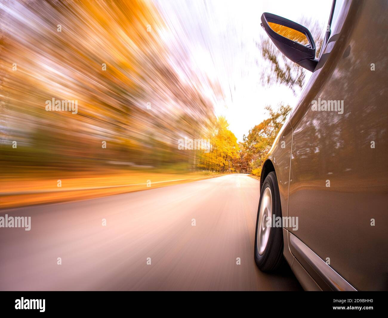 Speeding Car driving along an autumn road, USA Stock Photo