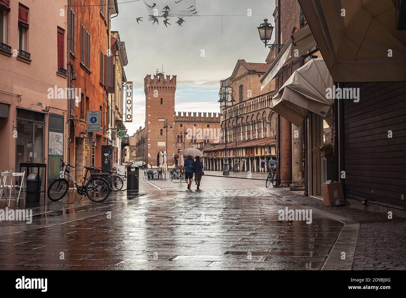 FERRARA, ITALY 29 JULY 2020 : Ferrara alley with a view of the castle and the main square Stock Photo