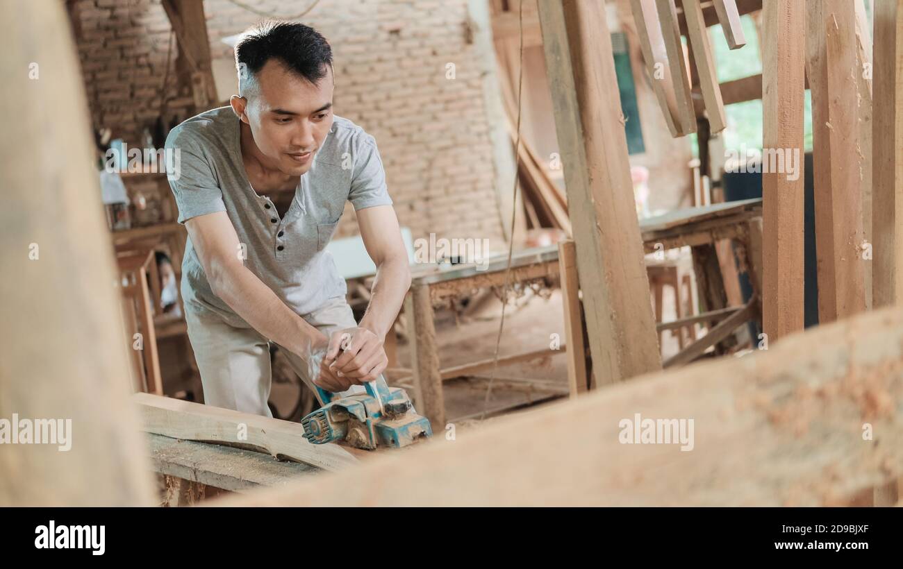 carpenters work using electric wood dowels while in a workshop Stock Photo