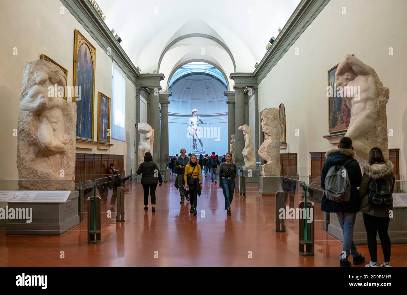 Florence, Italy - February 14, 2019: Accademia Gallery, sculptures unfinisced I Prigioni and sculpture of David in the background, by Michelangelo Stock Photo