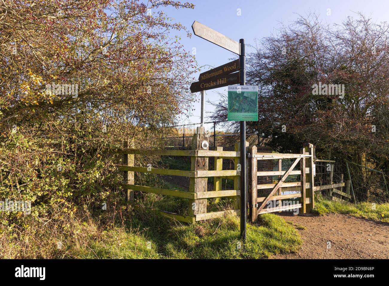 Crick, Northamptonshire - 4/11/20: A metal signpost by a gate on a footpath shows directions to various parts of a public open recreational space. Stock Photo