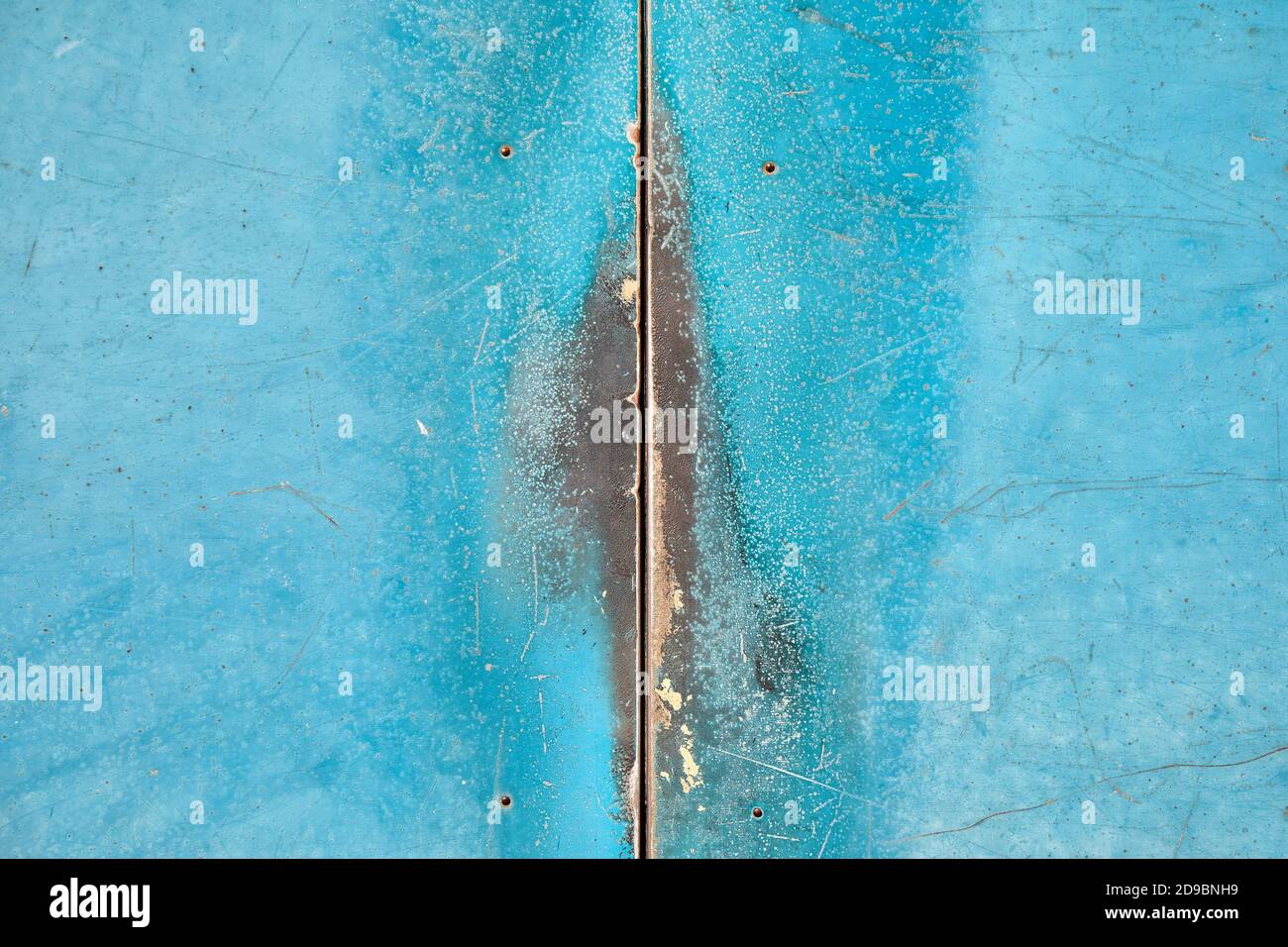 Crack between worn metal doors, turquoise Stock Photo