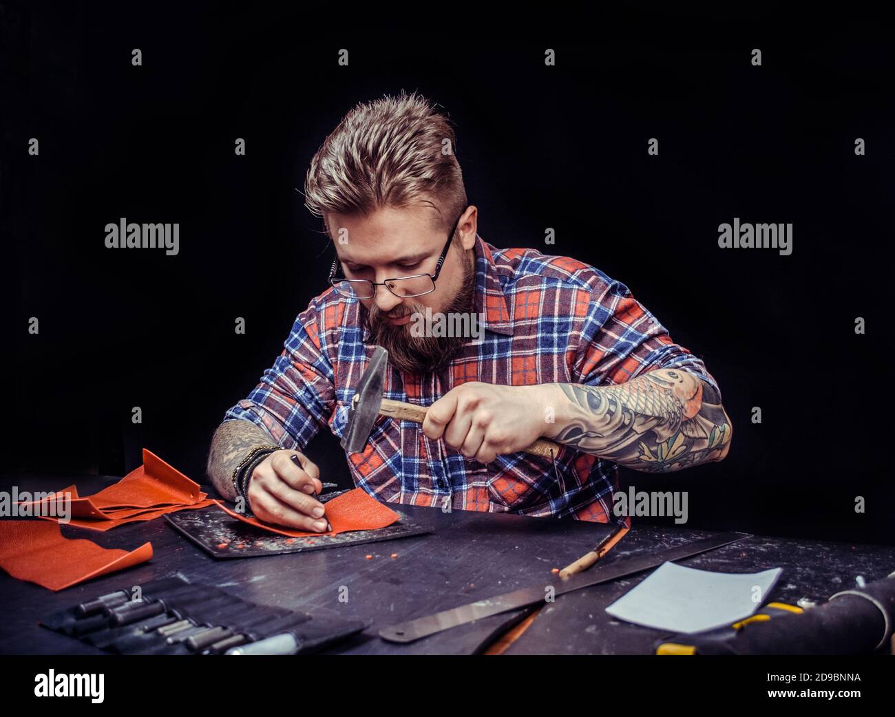Leather Artist producing leather workpiece at the shop Stock Photo