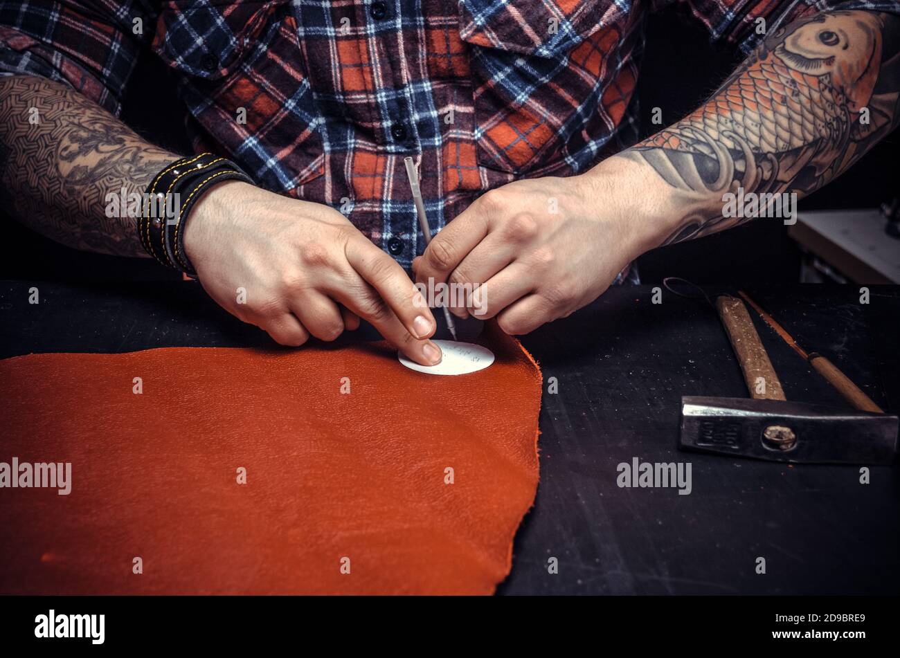 Worker of leather producing leather goods Stock Photo