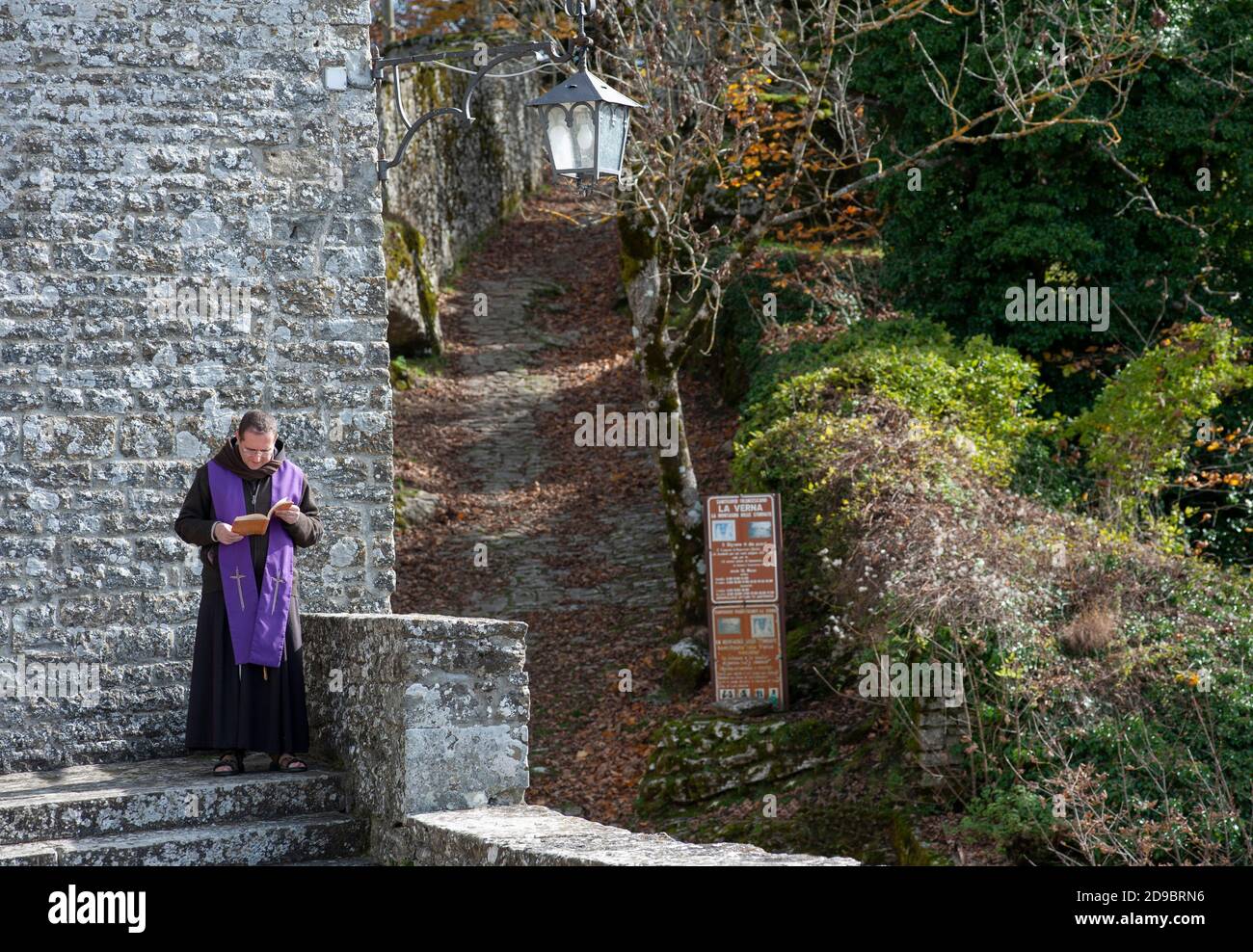 Chiusi della Verna, Arezzo, Italy - 2020, October 30:  Monk in prayer near the abbey church. Stock Photo