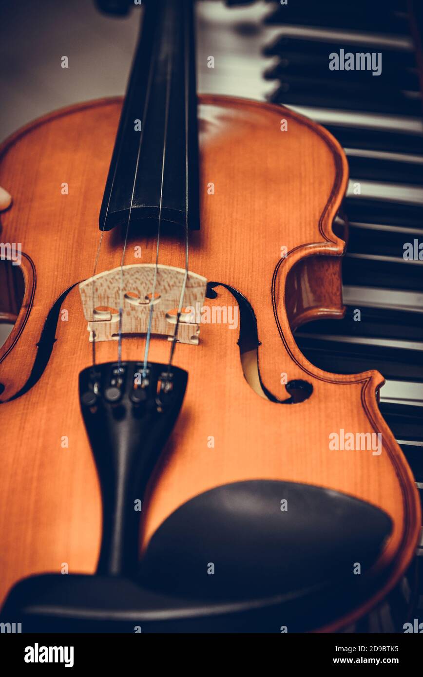 The violin is on the synthesizer keys. Stock Photo