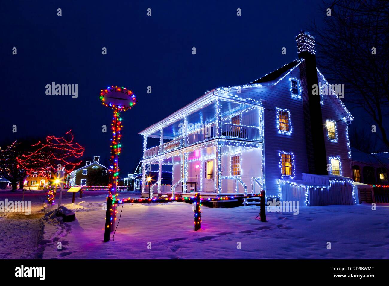 Heritage buildings, trees and fences decorated with Christmas lights at