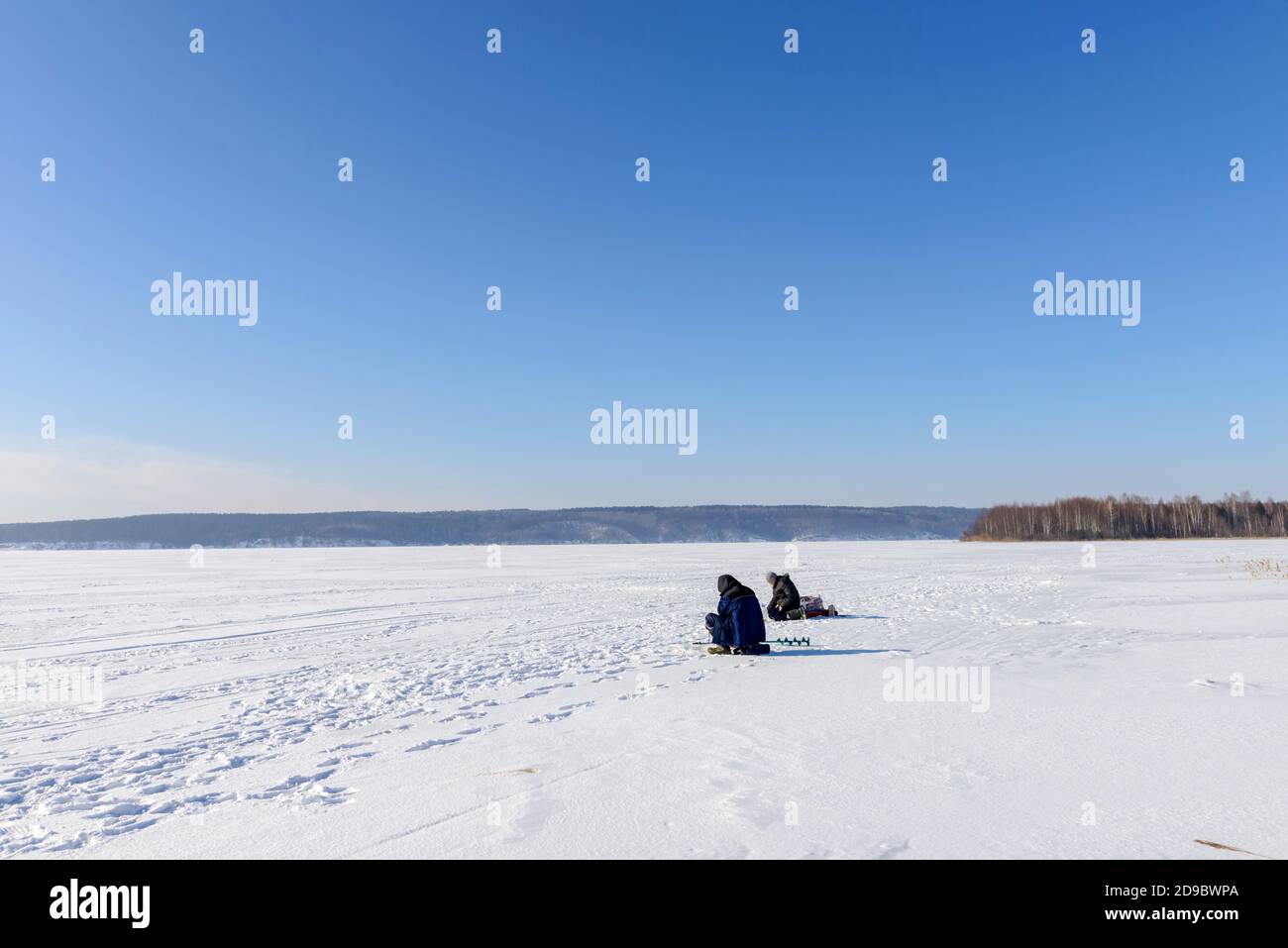 Winter fishing. Ice fishing. Fishermans, fishing on the ice. Russia. Stock Photo
