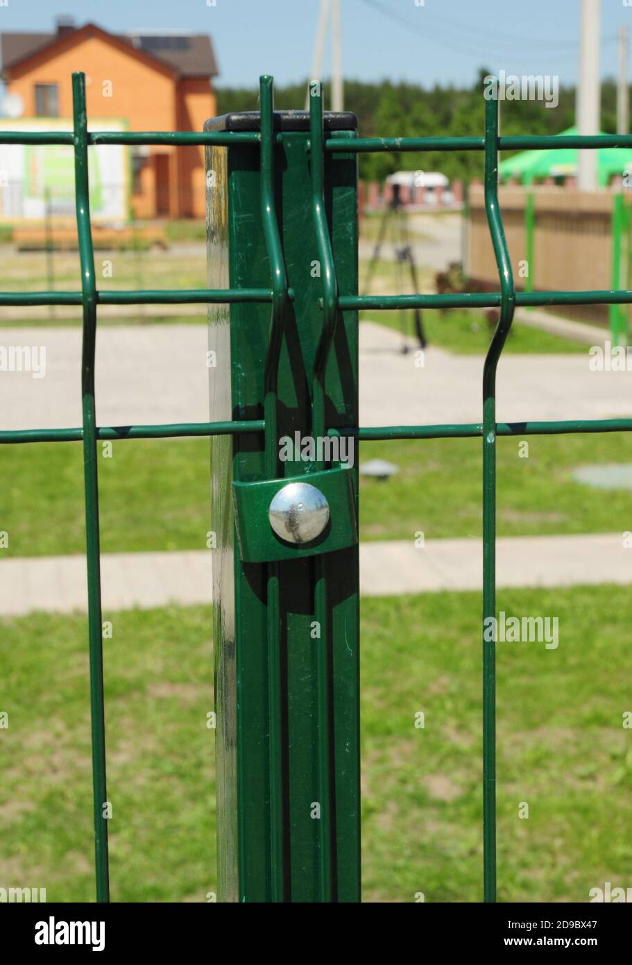 Metal post set in the ground with concrete footing of a metal railing fence  Stock Photo - Alamy