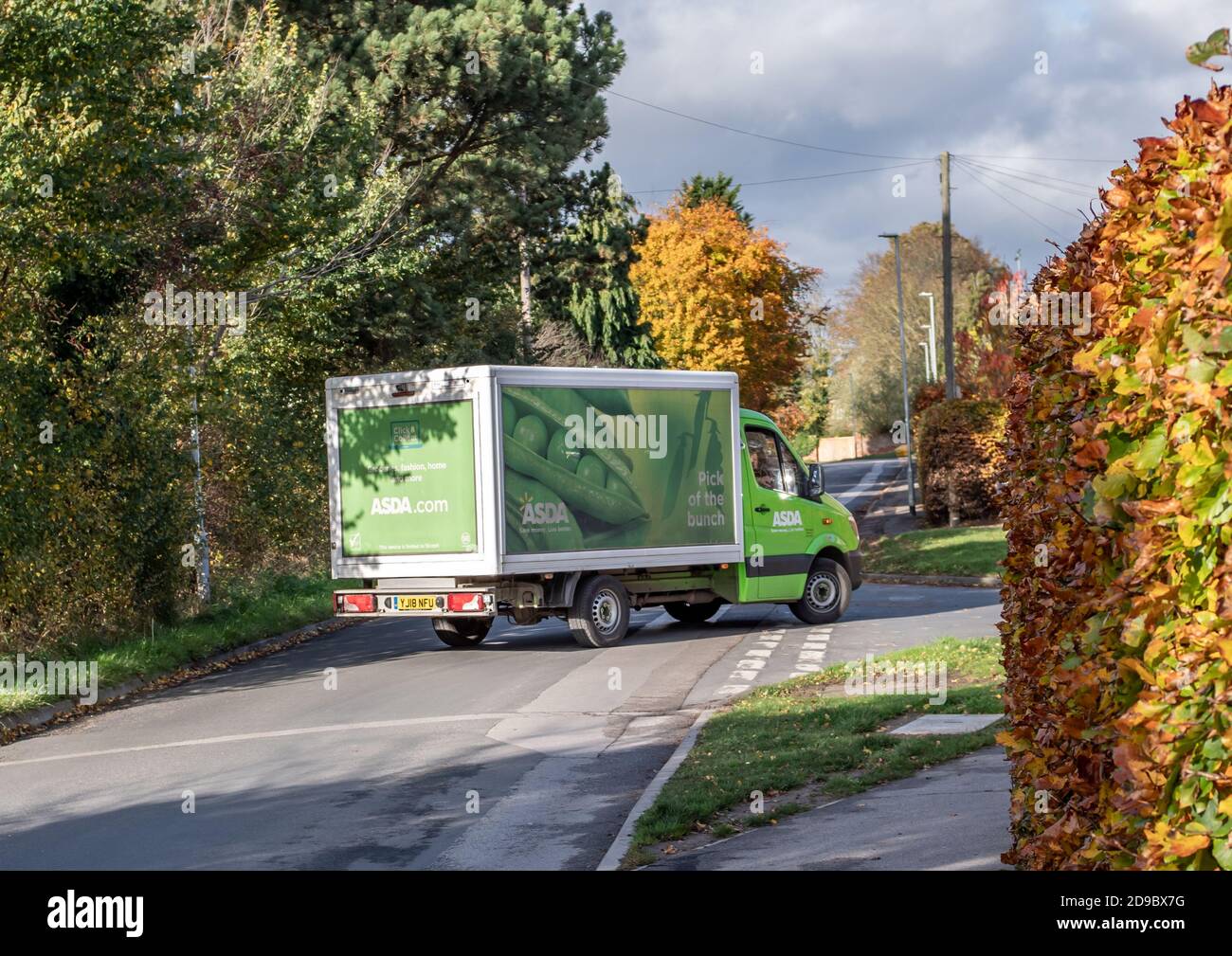 Pocklington, East Yorkshire, England, 03/11/2020 - A green Asda supermatket delivery van turning a corner in the street Stock Photo