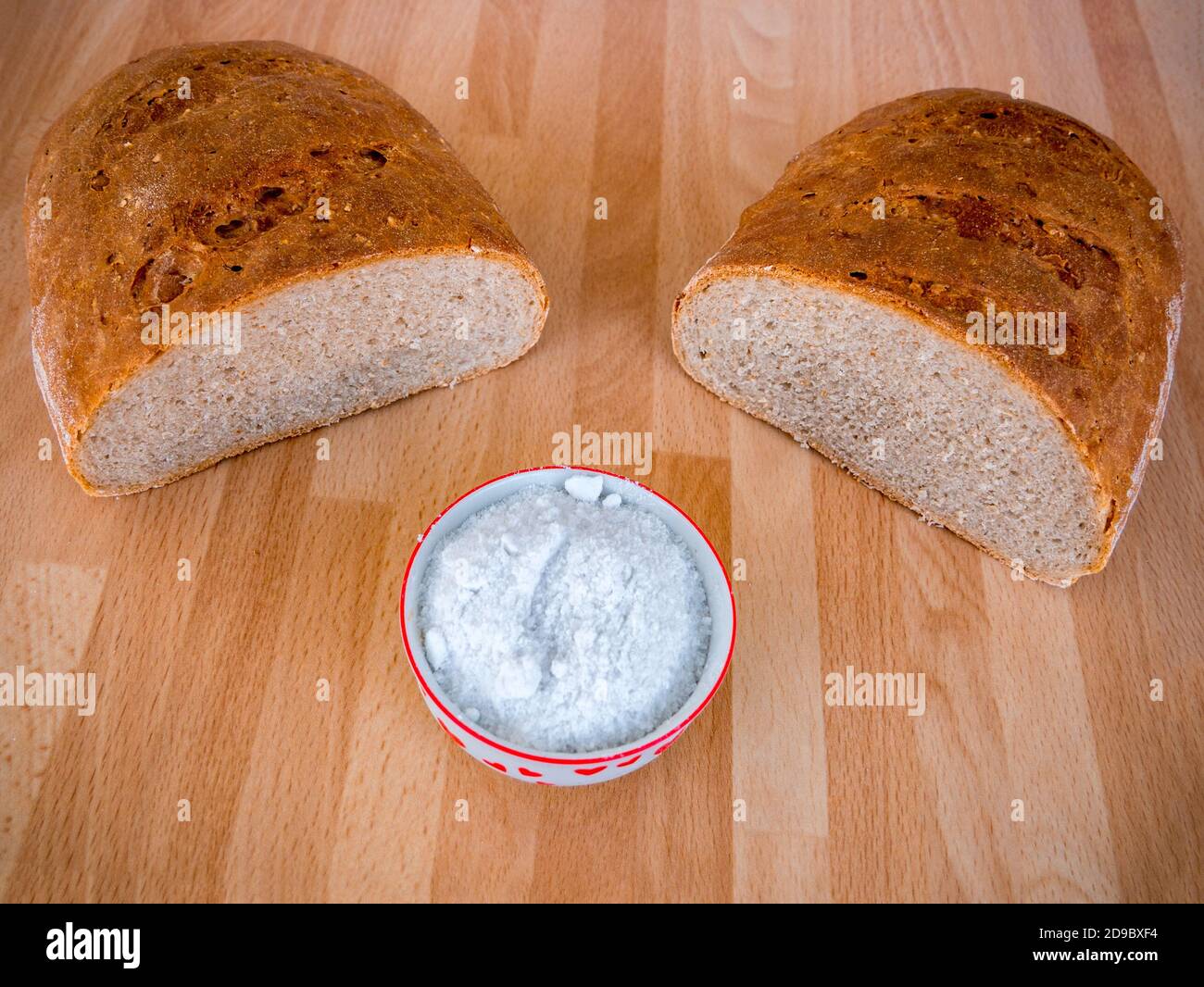 Halved homemade traditional bread and salt in a bowl Stock Photo