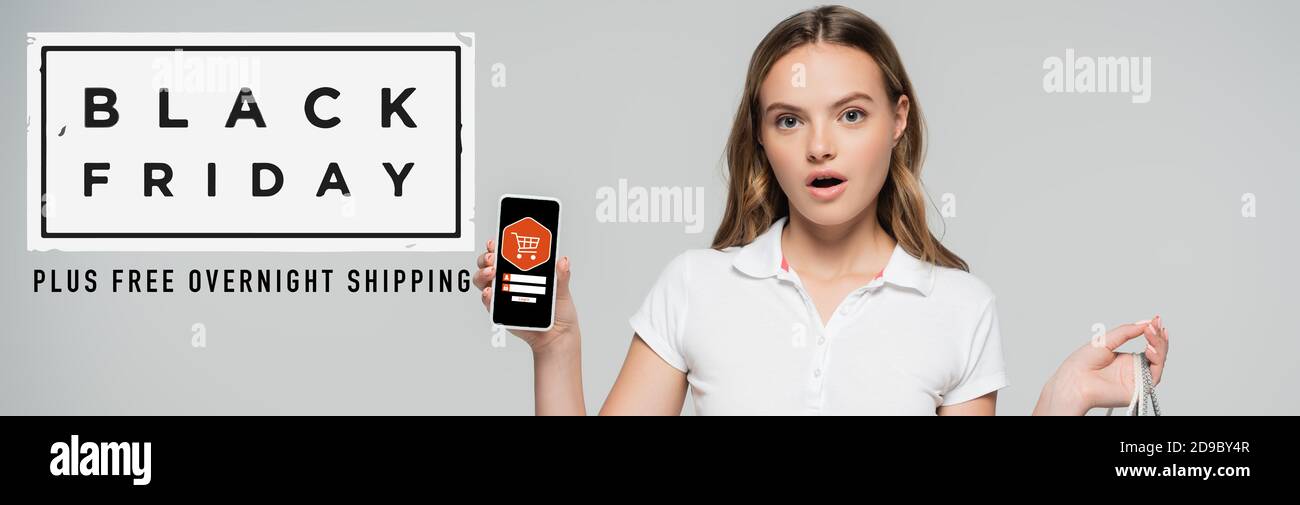 shocked woman holding smartphone near black friday lettering and illustration on grey, banner Stock Photo