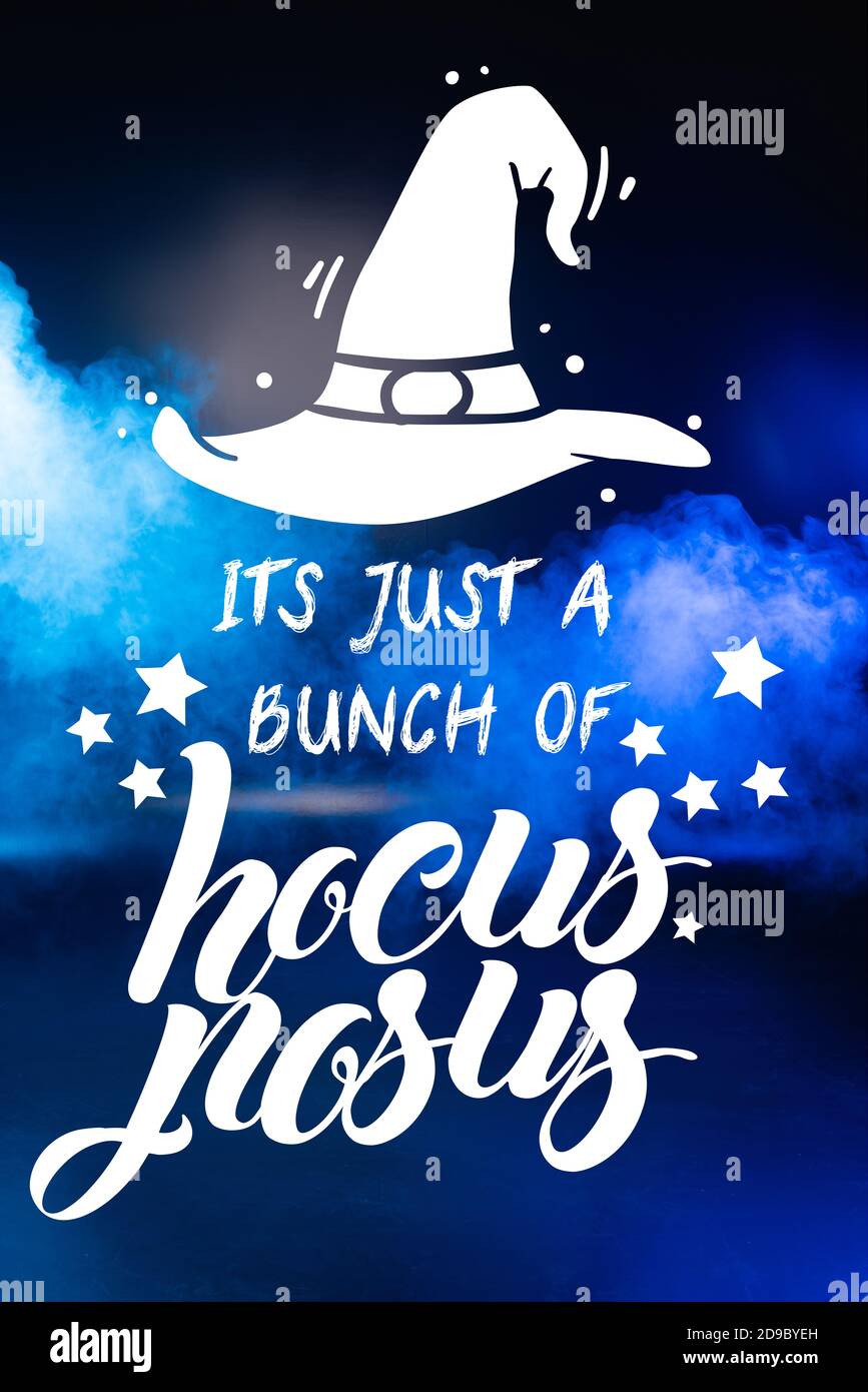 it is just bunch of hocus pocus lettering on blue dark background with smoke Stock Photo