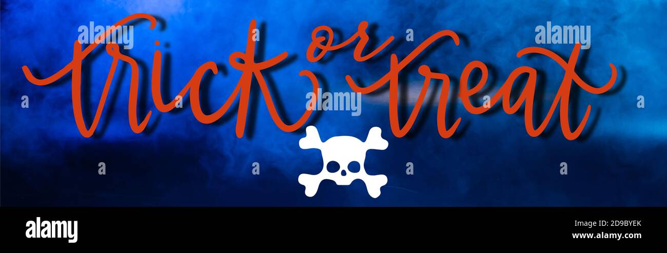 trick or treat lettering on blue dark background with smoke, banner Stock Photo