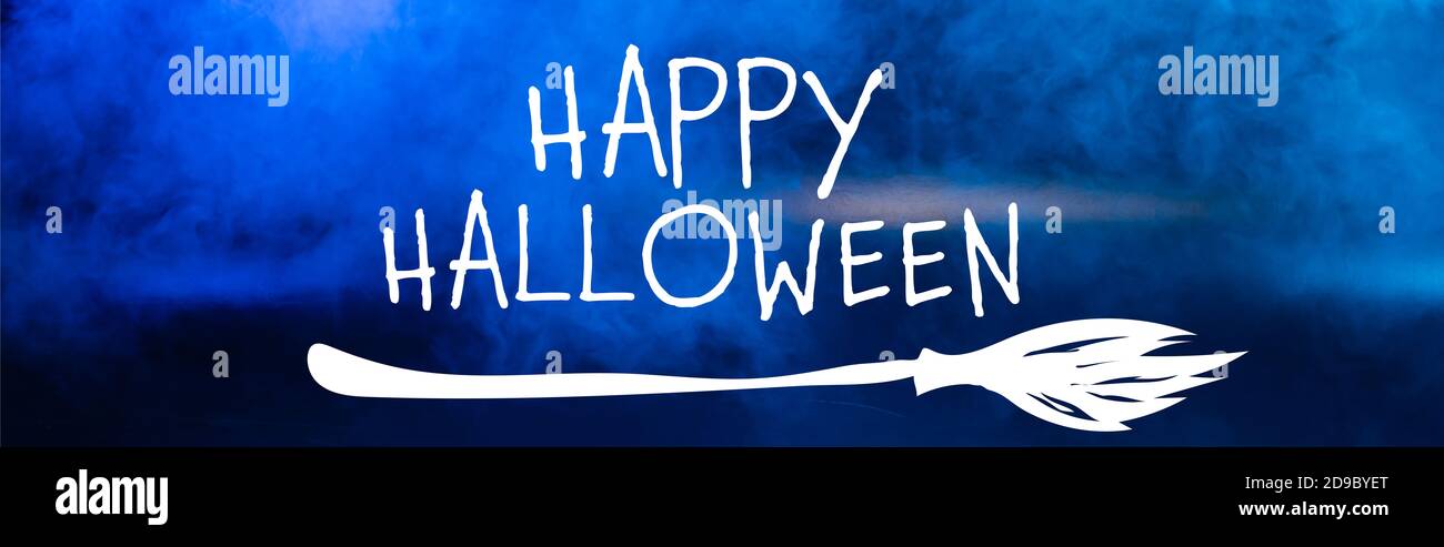 happy halloween lettering on blue dark background with smoke, banner Stock Photo