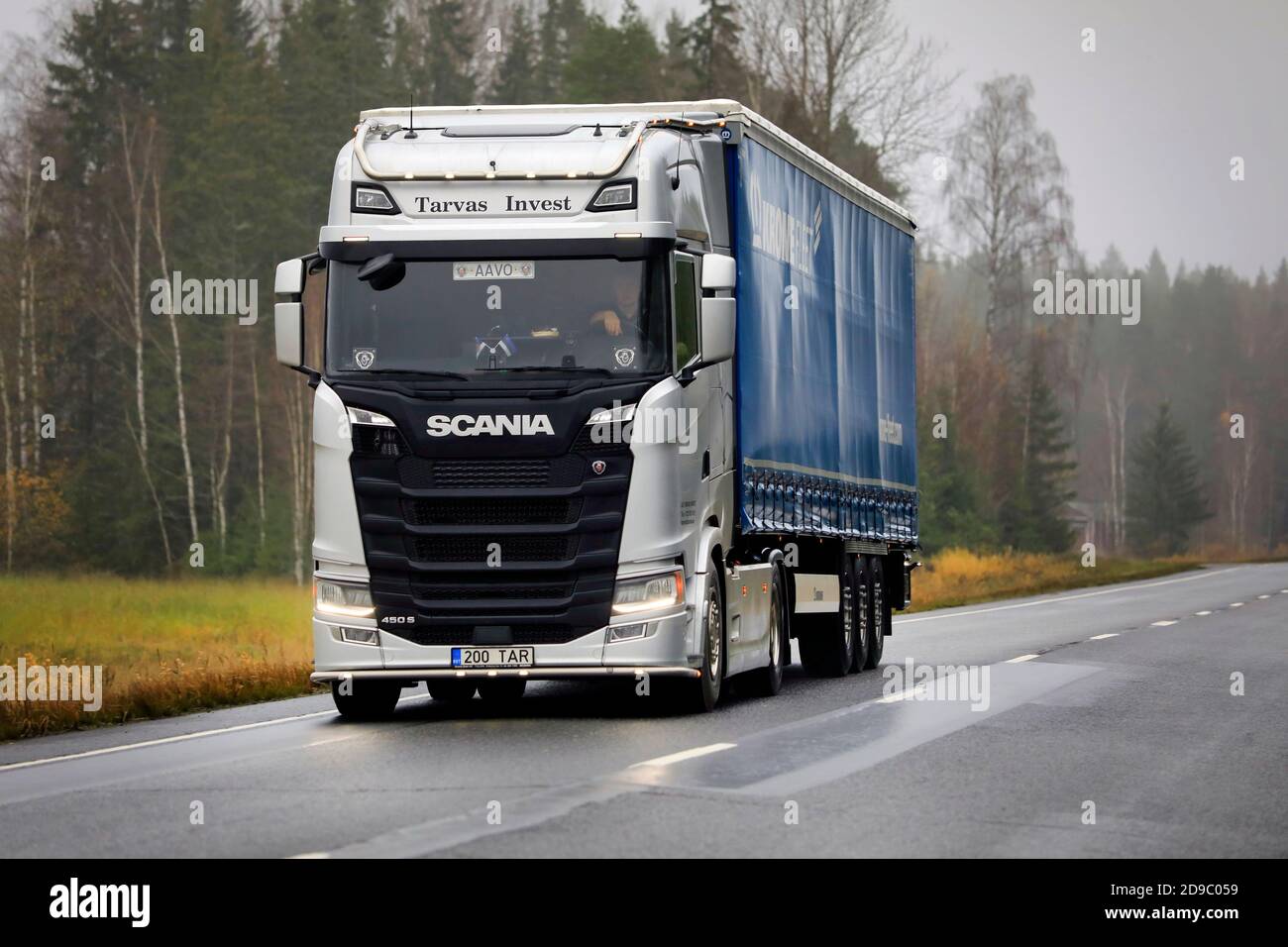 New, silver Scania 450 S truck pulls trailer along highway 10 on a rainy, foggy morning. Marttila, Finland. October 30, 2020. Stock Photo