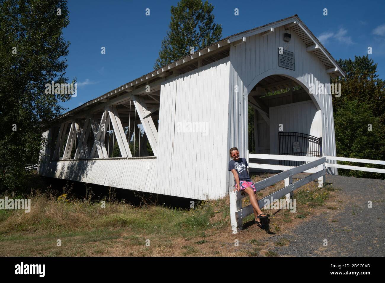Sweet Home, Oregon August 2, 2020 Adult woman poses on the fence