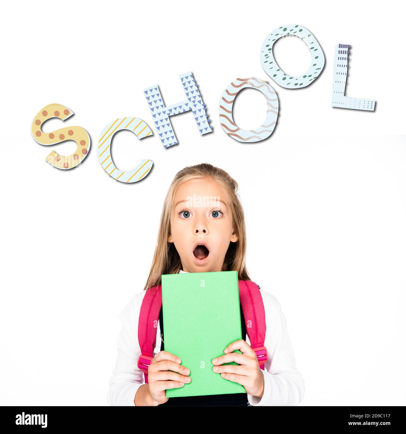 shocked schoolgirl holding book while looking at camera isolated on white, school illustration Stock Photo