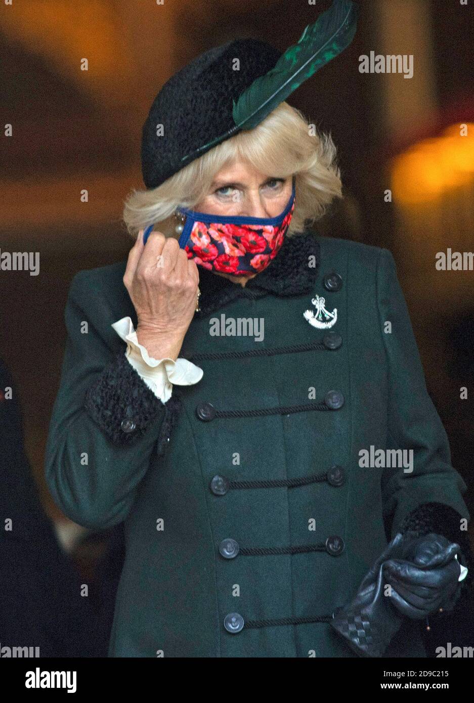 The Duchess of Cornwall, Patron of The Poppy Factory, wearing a poppy covered mask, during a visit to the Field of Remembrance, in its 92nd year, at Westminster Abbey in London, ahead of Armistice Day. Stock Photo