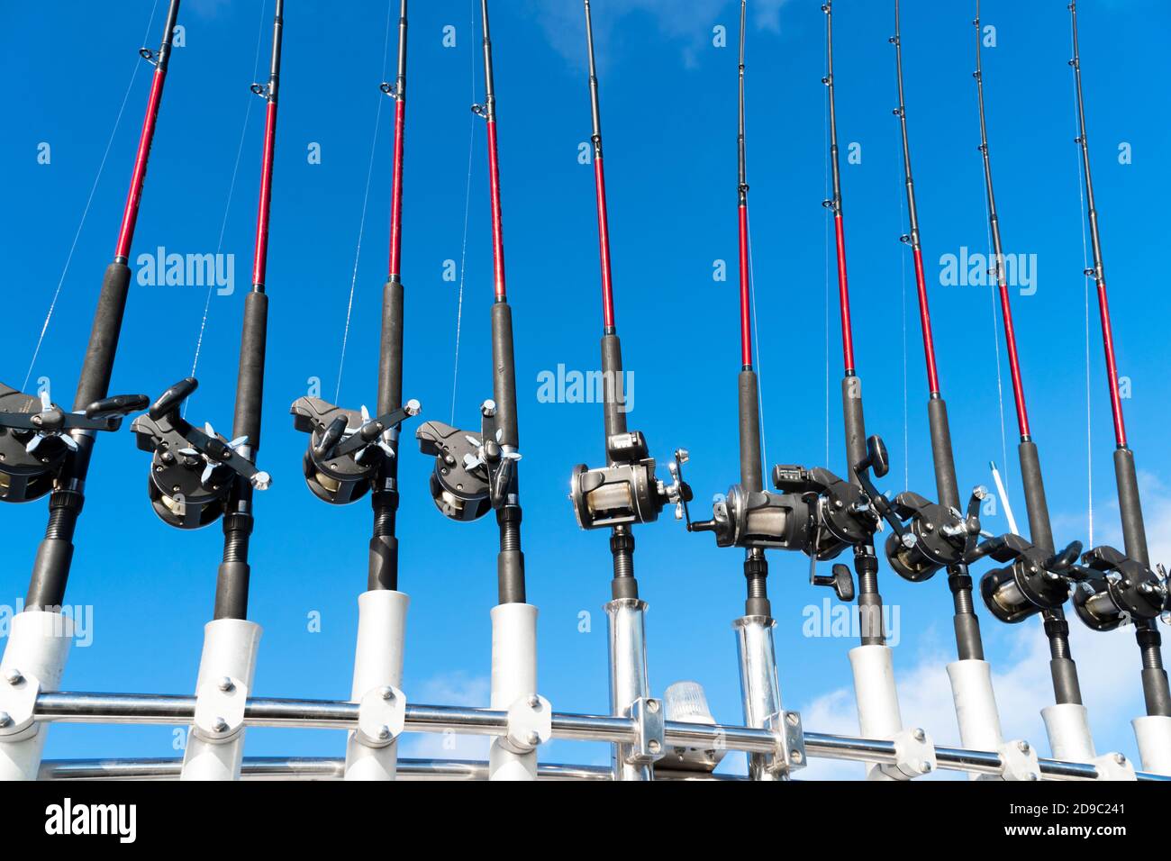 https://c8.alamy.com/comp/2D9C241/fishing-trolling-boat-rods-in-rod-holder-big-game-fishing-fishing-reels-and-rods-pattern-on-boat-sea-fishing-rods-and-reels-in-a-row-2D9C241.jpg