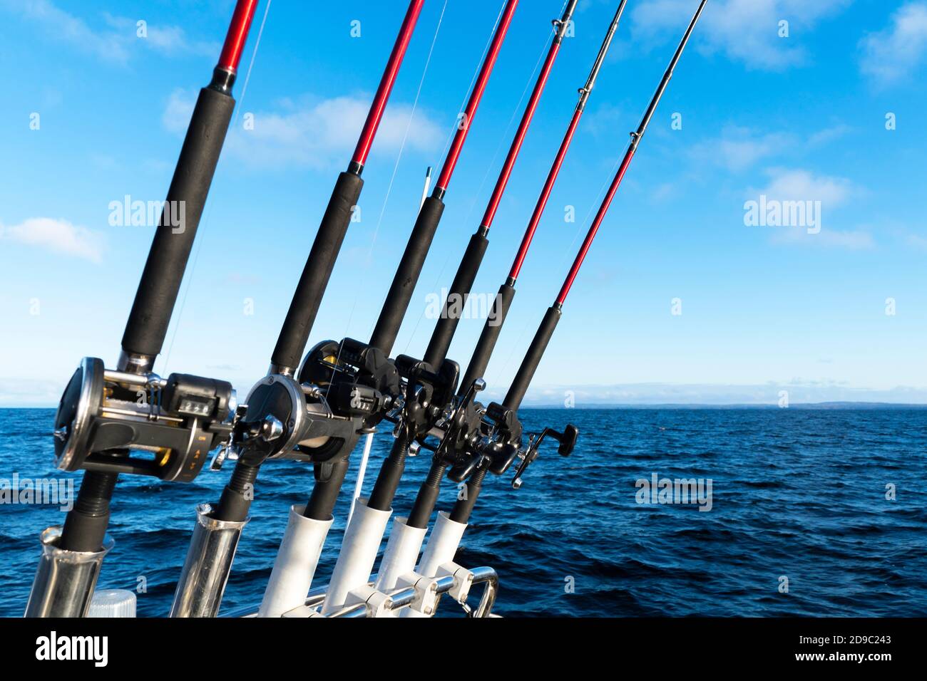 https://c8.alamy.com/comp/2D9C243/fishing-trolling-boat-rods-in-rod-holder-big-game-fishing-fishing-reels-and-rods-pattern-on-boat-sea-fishing-rods-and-reels-in-a-row-2D9C243.jpg
