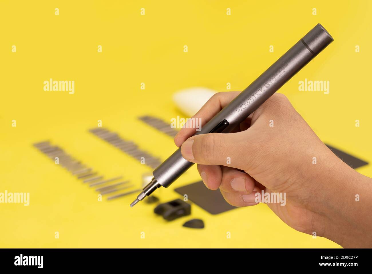 wowstick electric hand screwdriver for repair work and industry. tool on a white, yellow and blue background Stock Photo