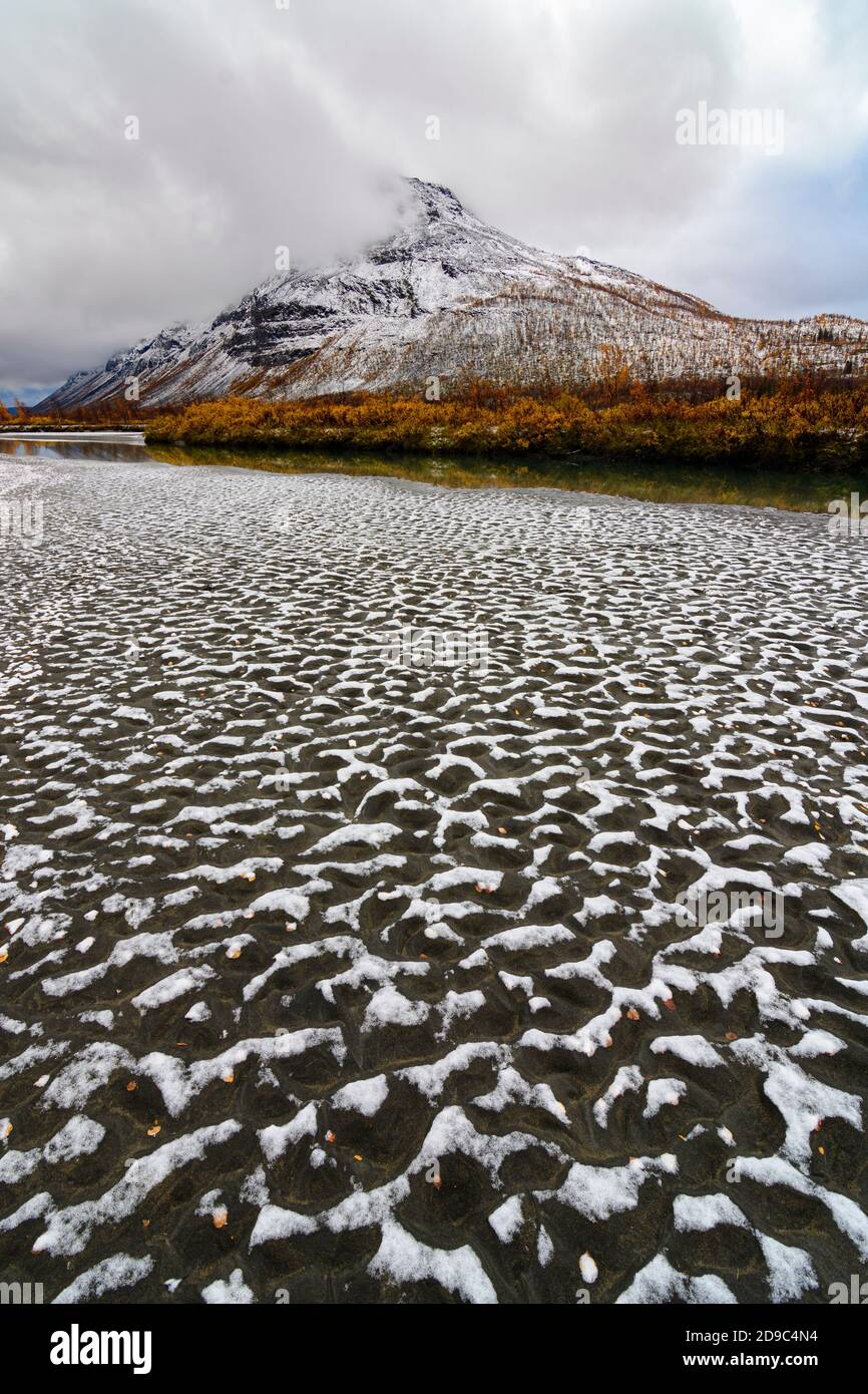 Snow patterns on a river shore of the Rapa river in Sarek National Park, Sweden Stock Photo