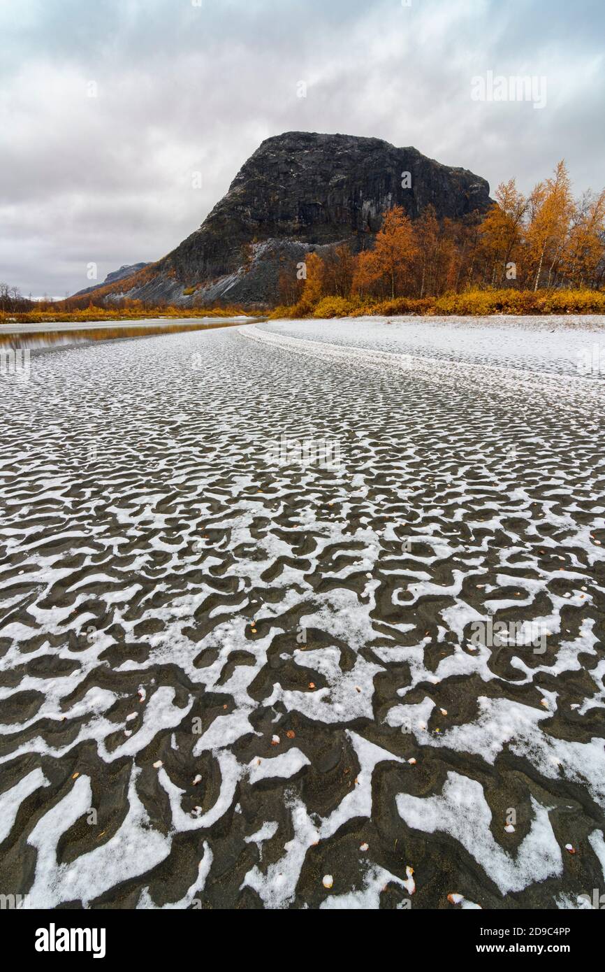 Snow patterns on a river shore of the Rapa river in Sarek National Park, Sweden Stock Photo