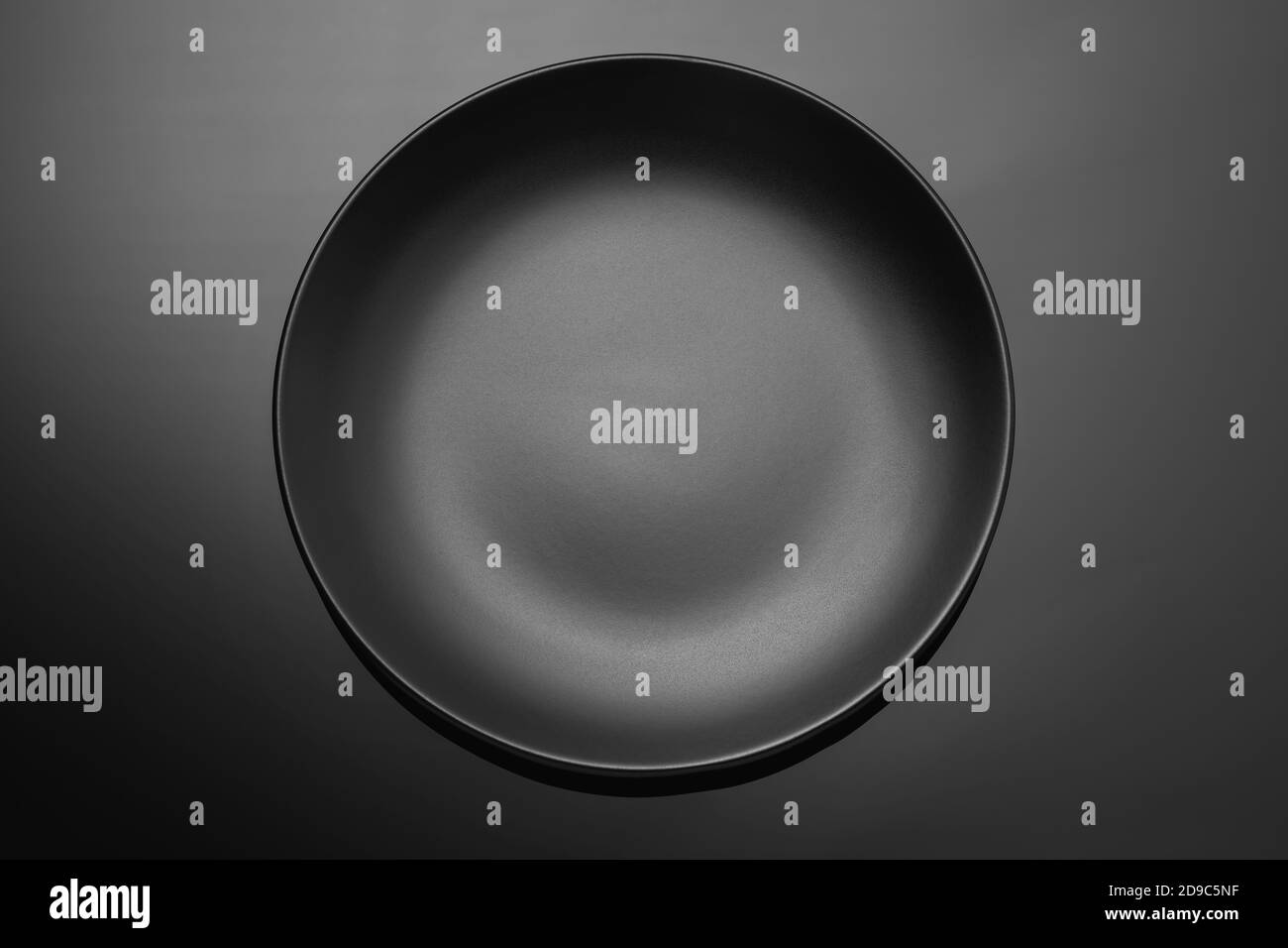 Empty black plate on a dark gradient background. Food background Stock Photo