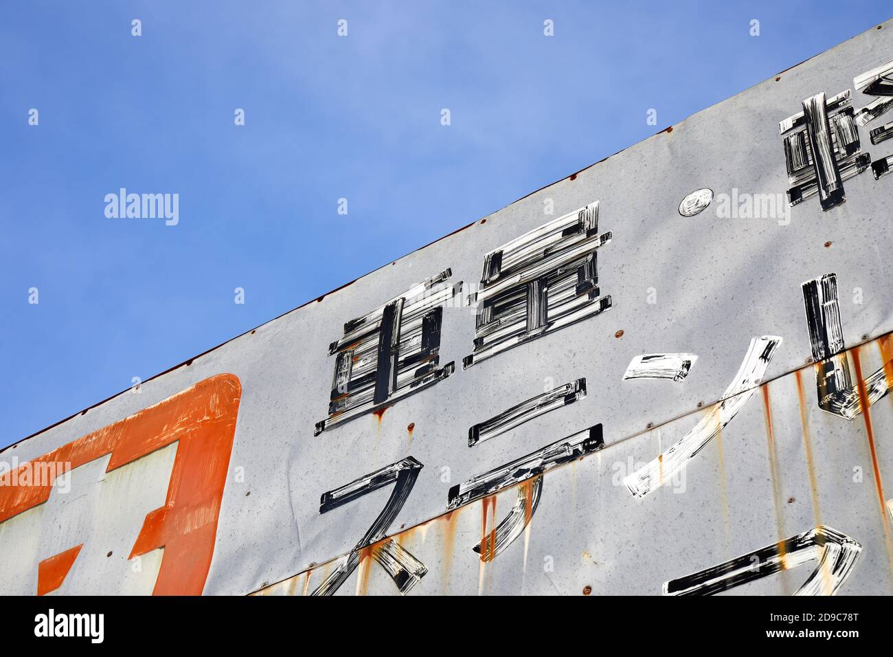 Painted metal sign, Japanese, on an old building; Tokyo, Japan Stock Photo