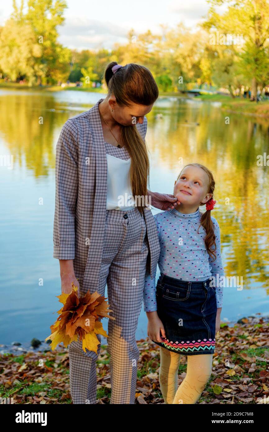 Happy mother and daughter having fun in the autumn Park Stock Photo - Alamy