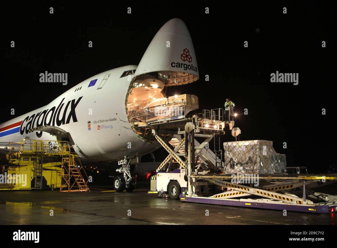 Glasgow Prestwick Airport, Ayrshre, Scotland, UK, A Boeing Carolux 747-8f unloads at the airport at night time flooldlighting helps the operation Stock Photo