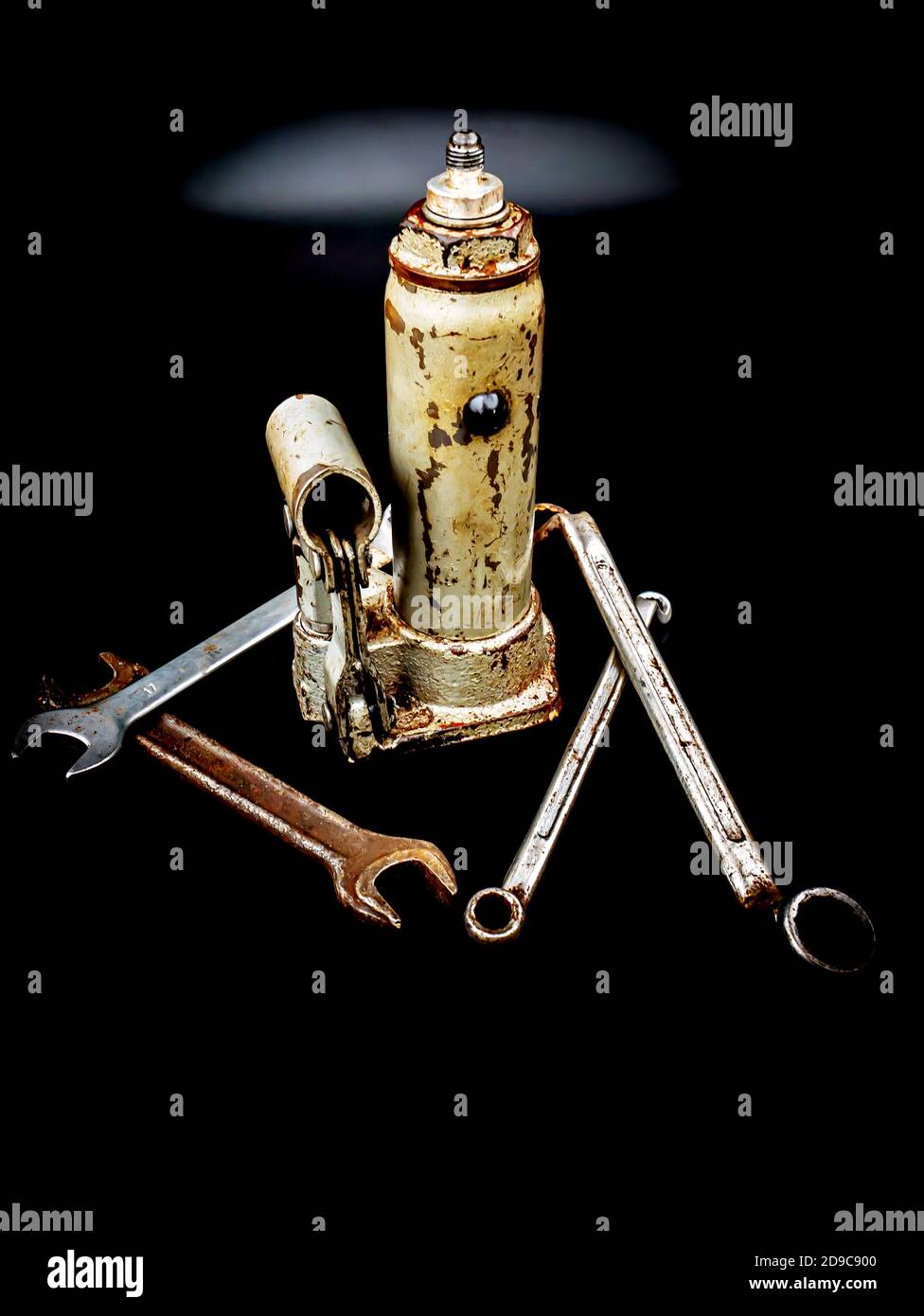 Hydraulic car jack and wrenches on a black background Stock Photo Alamy
