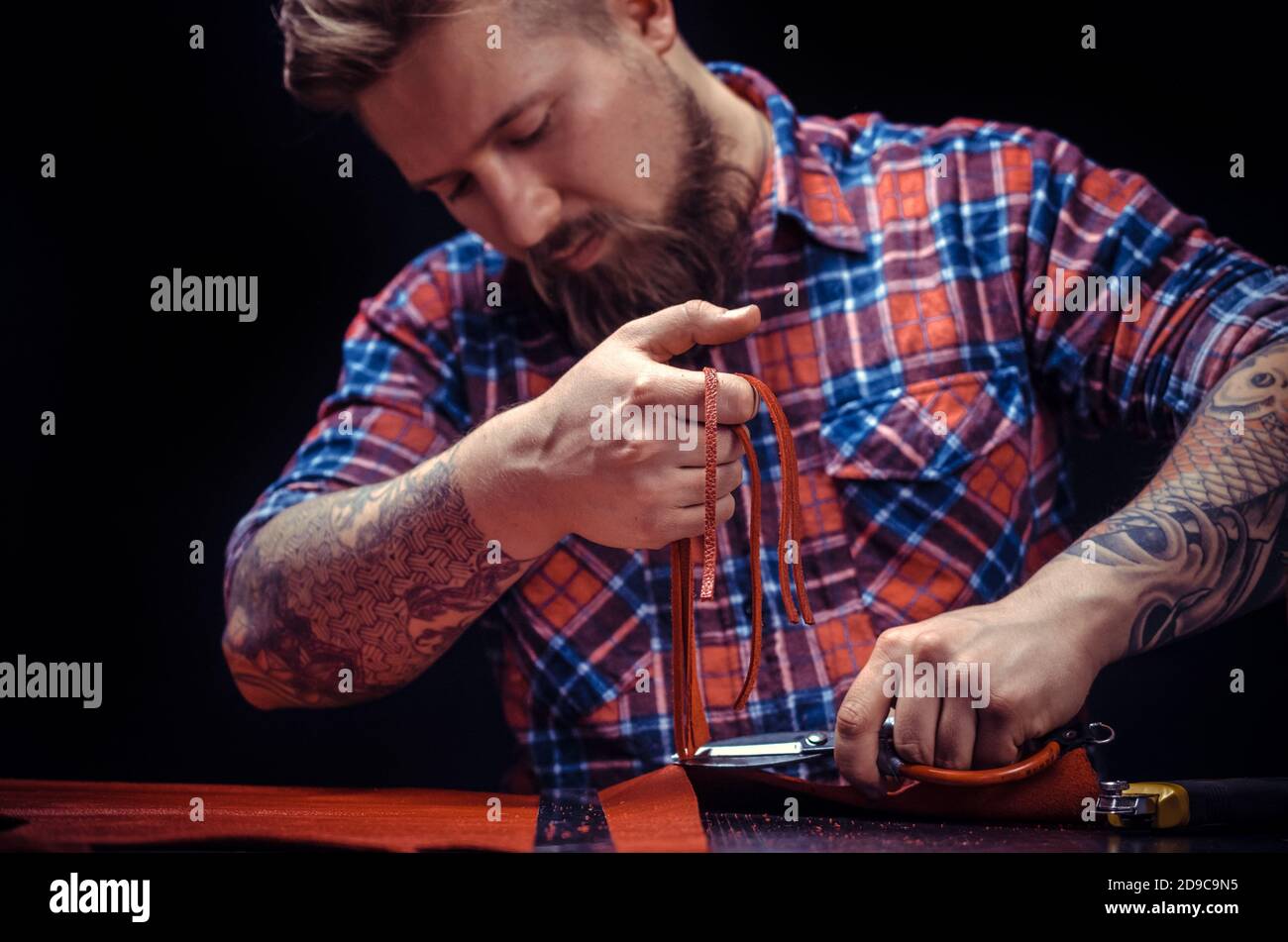 Craftsman working with leather produce a leatherwork Stock Photo