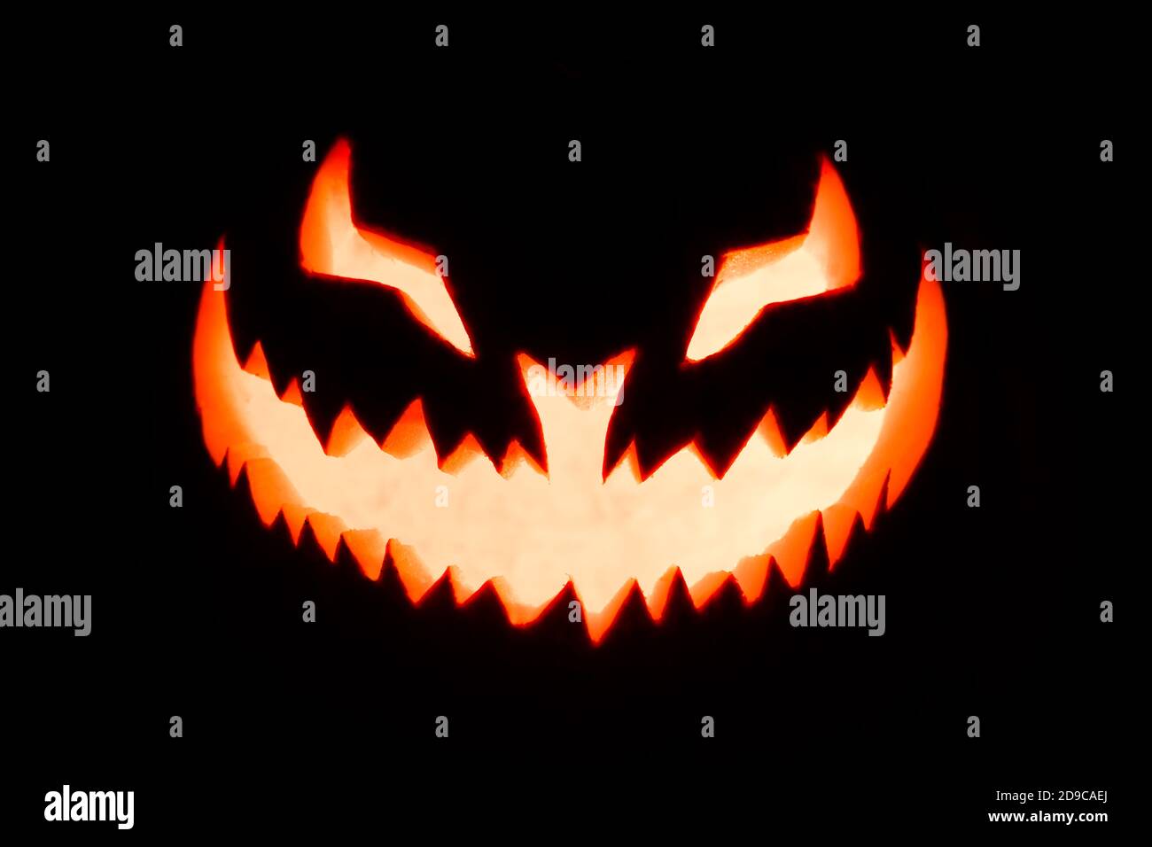 Carved pumpkin glowing in the dark Stock Photo - Alamy