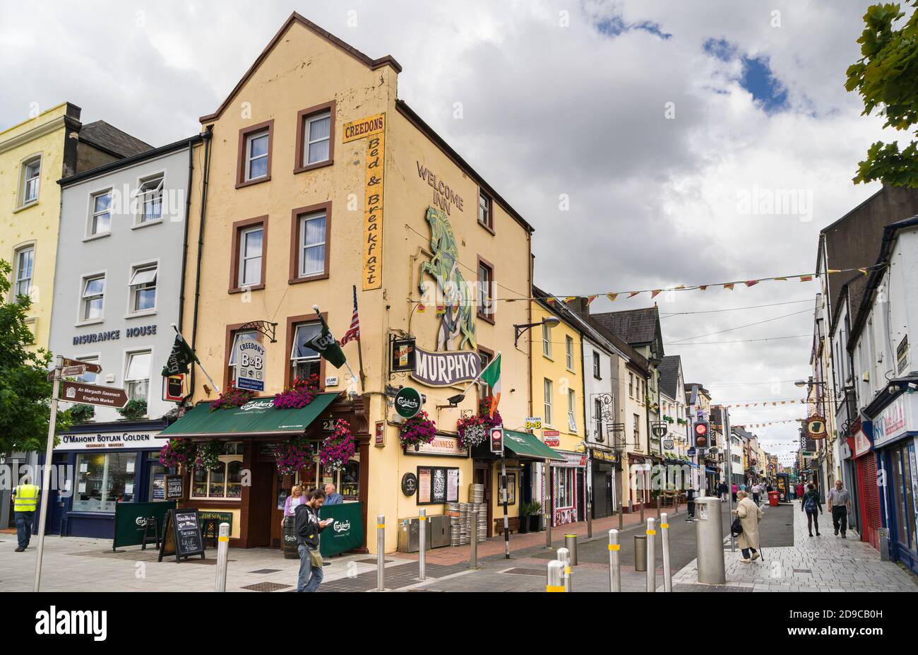 View of a street in the touristy Irish town of Cork with a pub in the foreground. Stock Photo