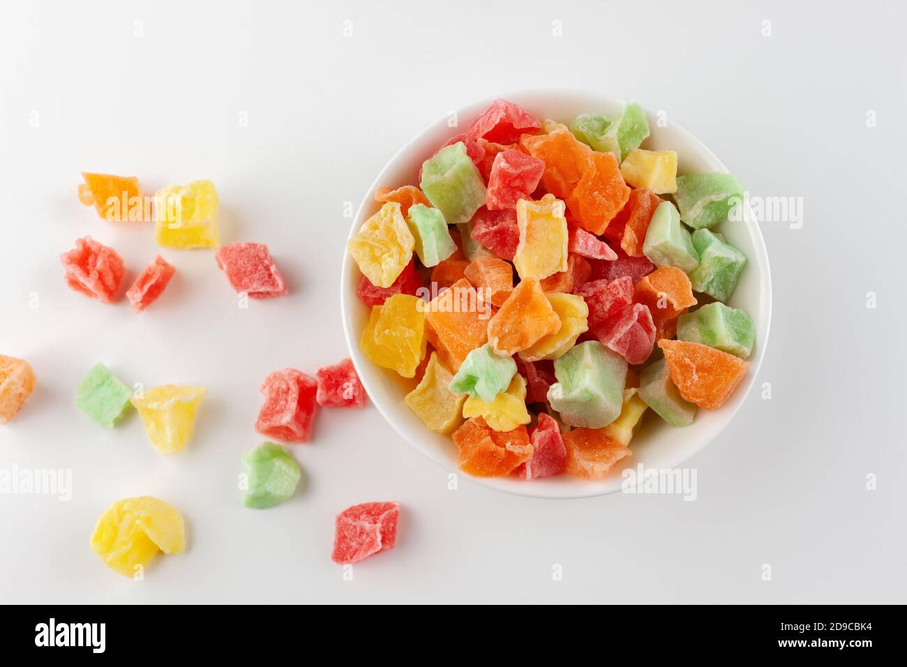 Candied fruits in a white bowl on a white background Stock Photo - Alamy